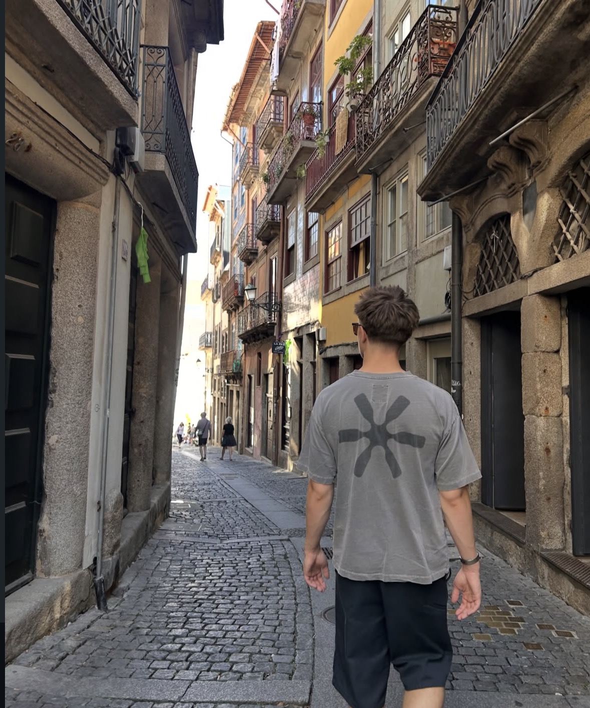 Ben Hudson walking along a cobbled street